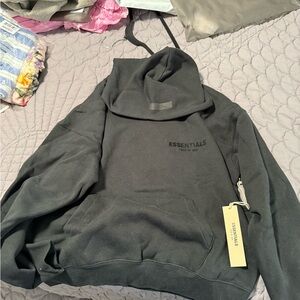 NWT XSEssentials fear of god Black Hoodie with small area of heat damage on back